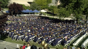 Wide shot of College of the Canyons graduates sitting at graduation.